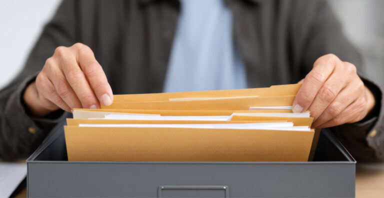 Organized tax and financial documents showing records retention guidance for what to keep and what to shred