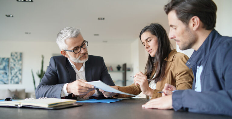 Family reviewing estate planning documents with a financial advisor